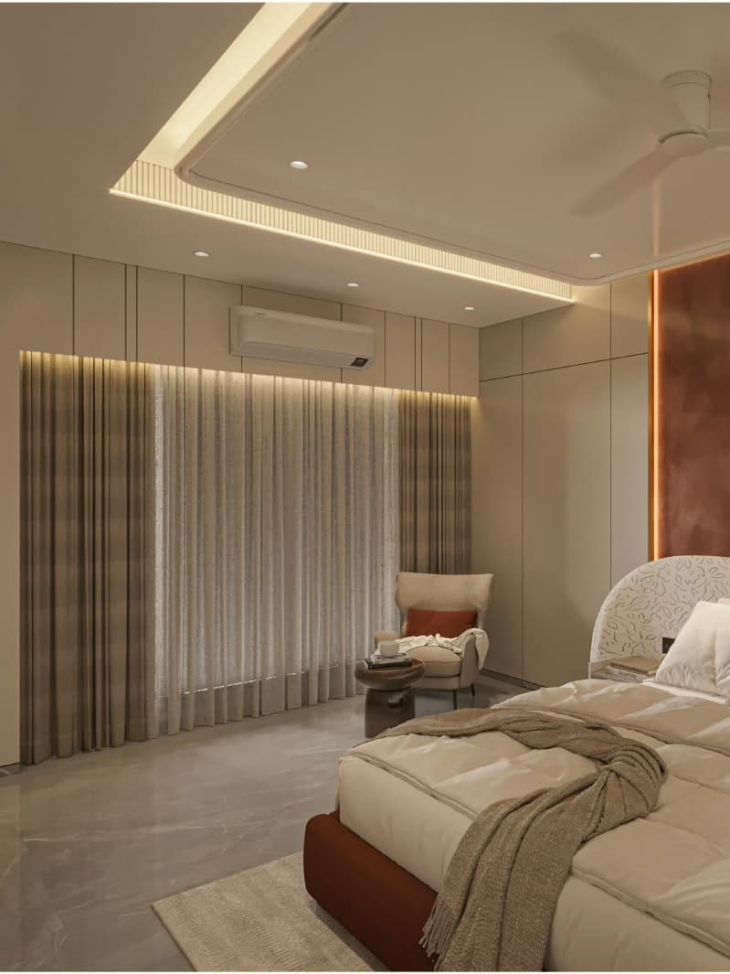 Cozy bedroom seating nook framed by layered sheer curtains and warm, recessed cove ceiling lighting.