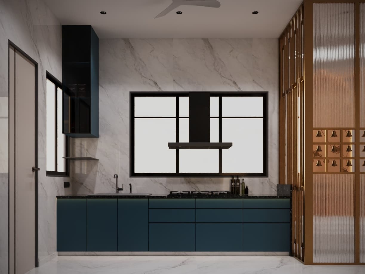 Parallel modular kitchen featuring sleek matte petrol-blue cabinetry, black granite countertop, and custom brass bell jali.