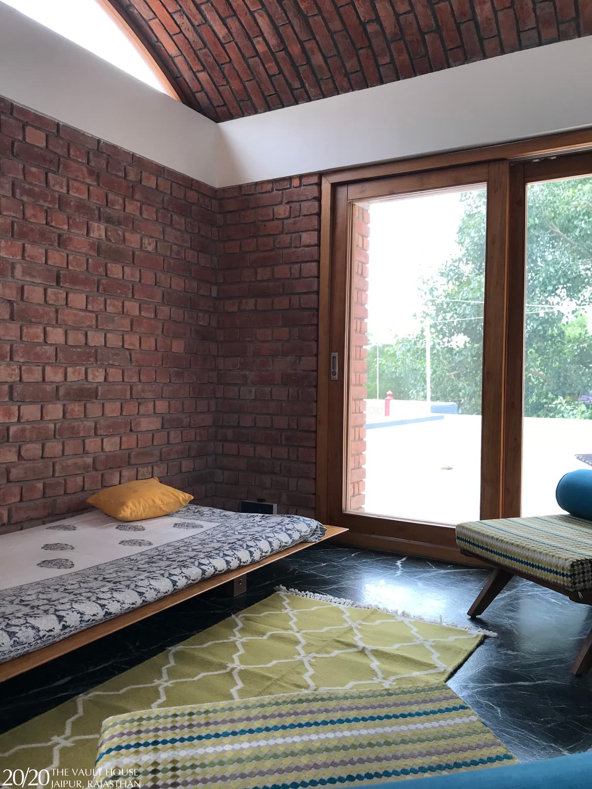 Brick, wood, and light converge, creating a space where structure feels both protective and liberating.
