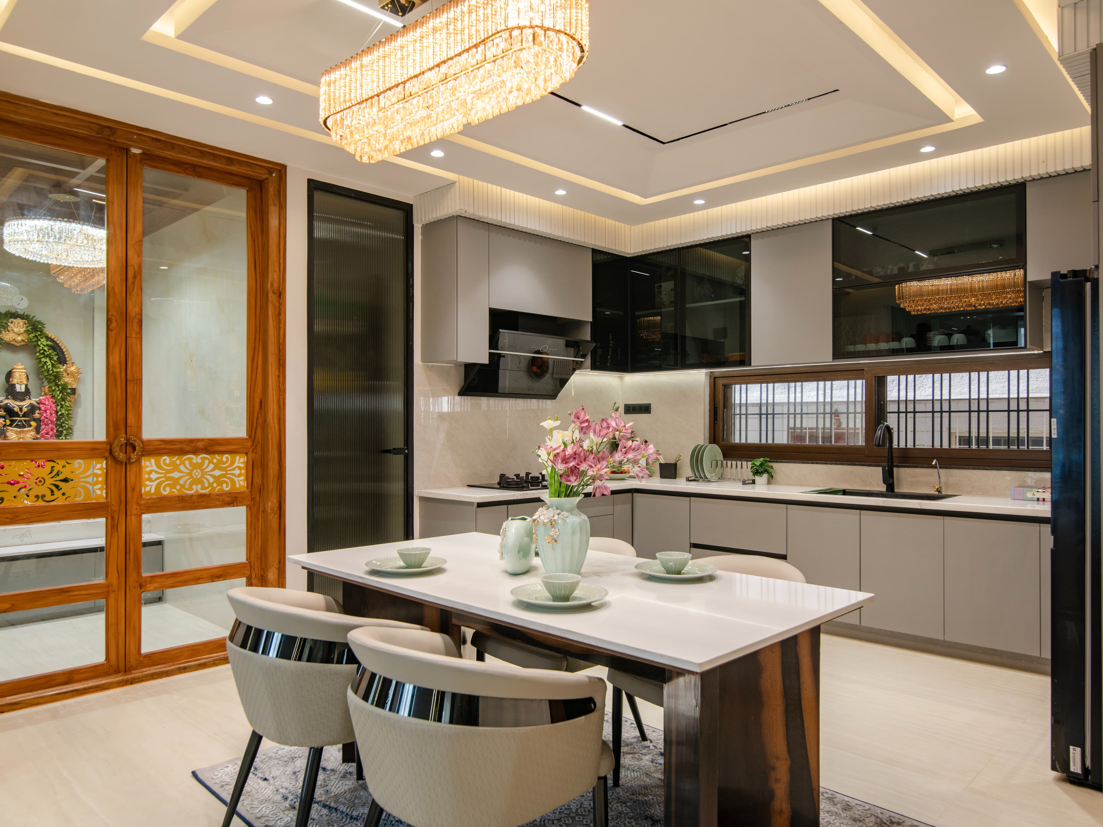 An open-concept kitchen that flows into the dining area, thoughtfully integrated with a dedicated pooja zone