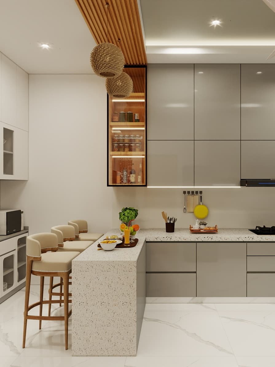 Elegant modular kitchen with extended breakfast counter, terrazzo countertop, glossy shutters and warm lighting designed for functional workflow and stylish contemporary living.