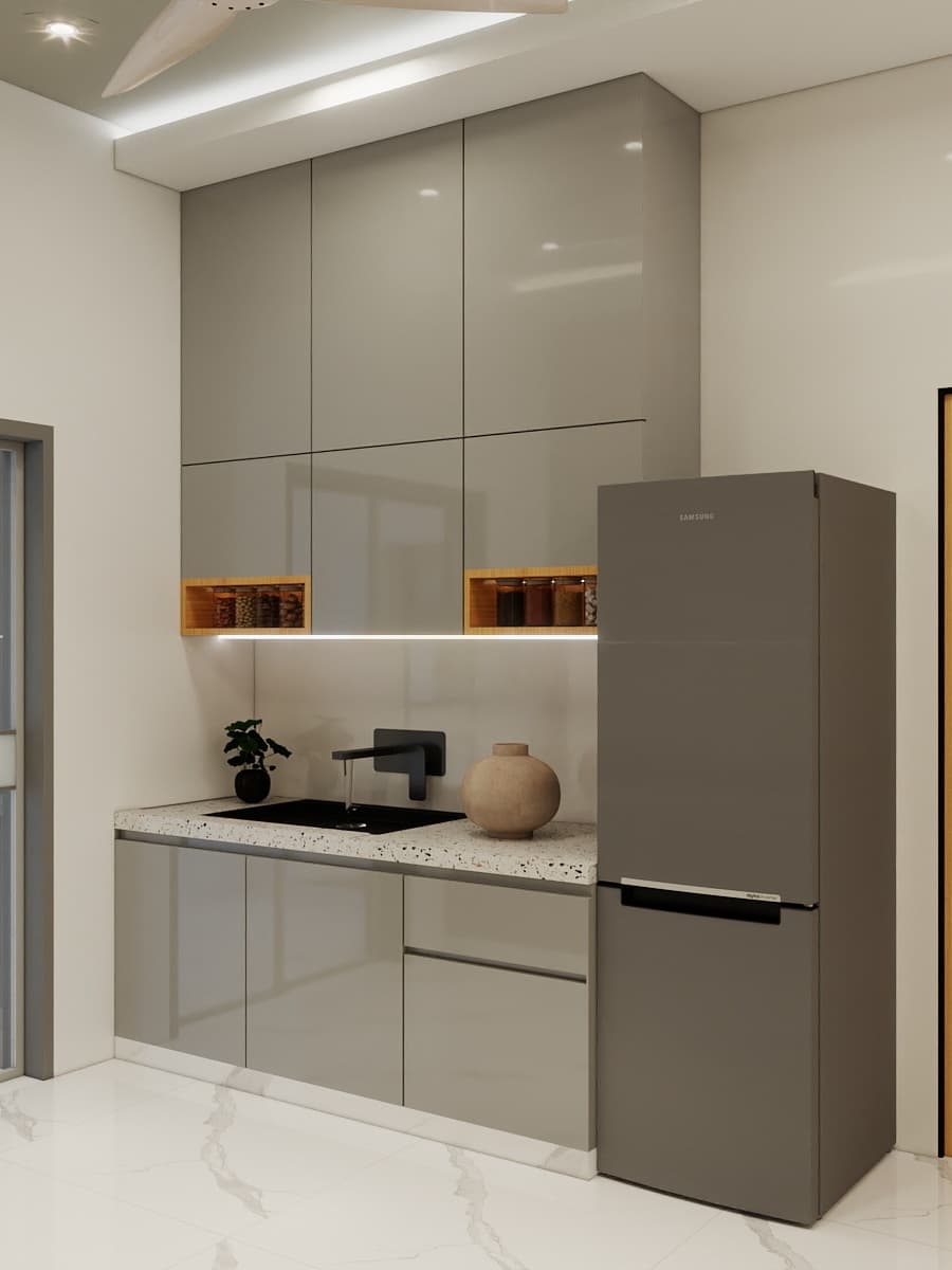 Sleek compact kitchen with glossy cabinets, terrazzo countertop, ambient profile lighting and minimal accessories offering a clean, functional and contemporary interior experience.